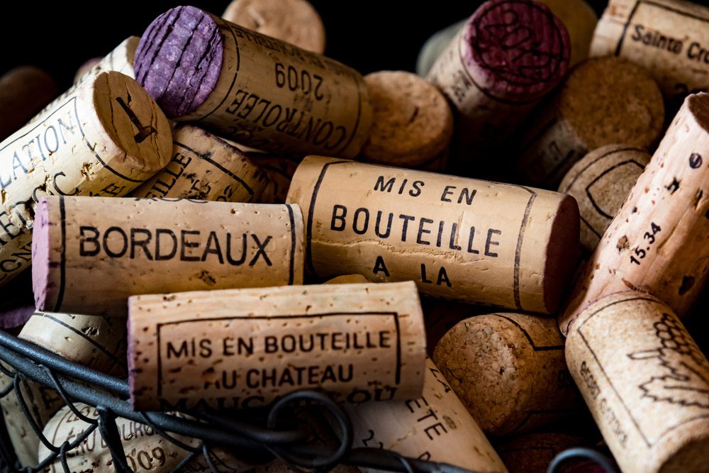 Old corks from French wines in a wire basket