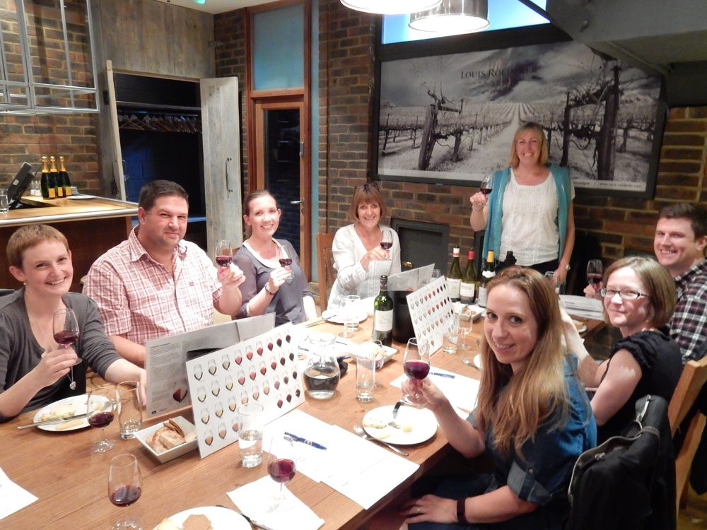 a group of guests and a tutor enjoying a wine tasting in london