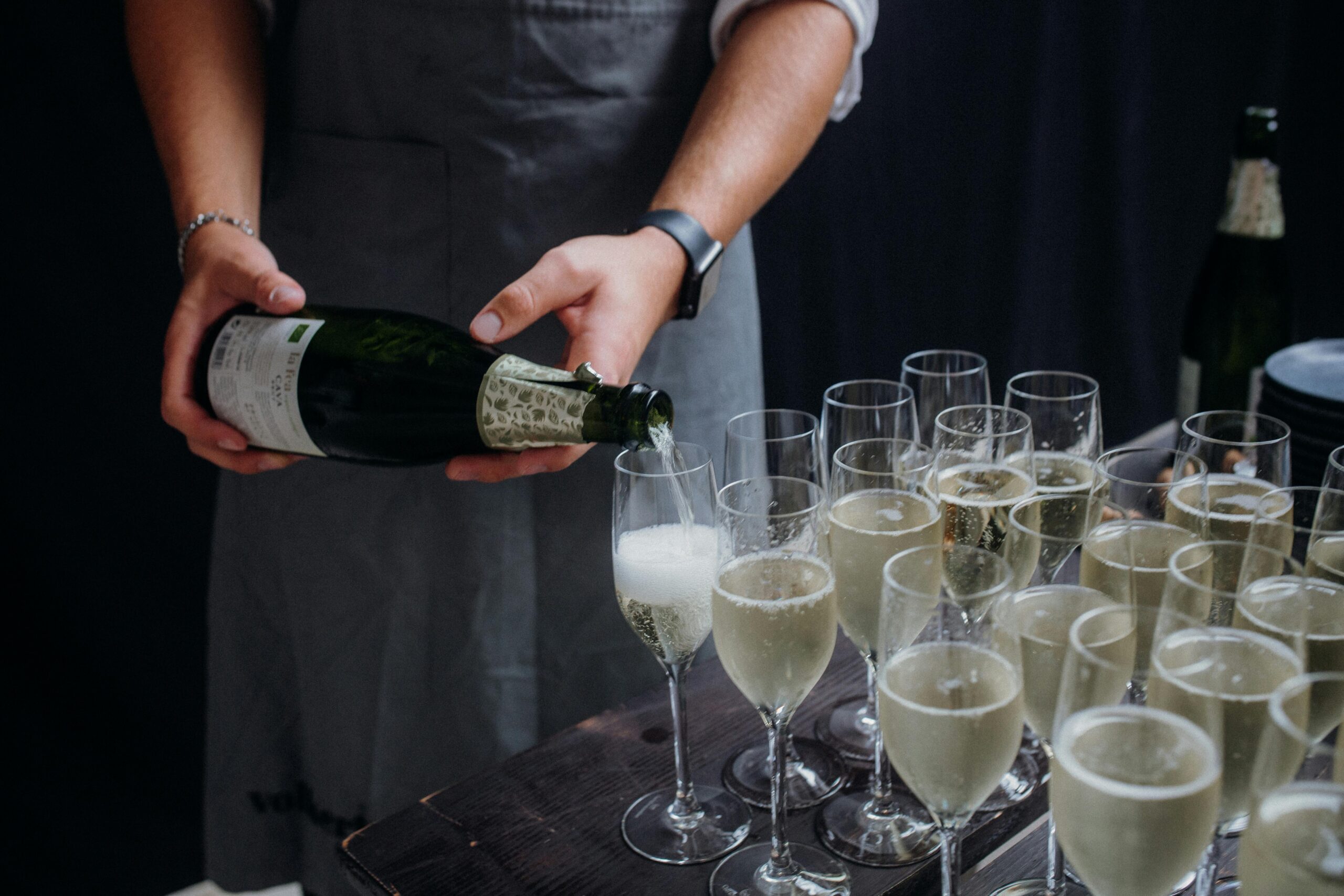 Sparkling wine being poured into flutes