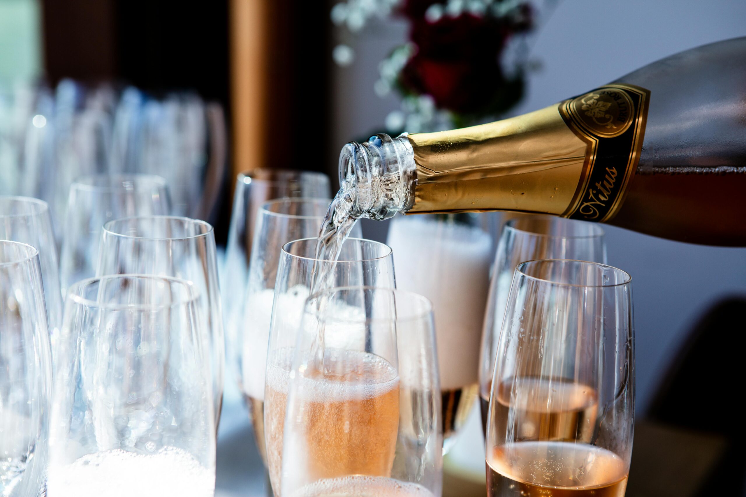 Rose sparkling wine being poured into glasses