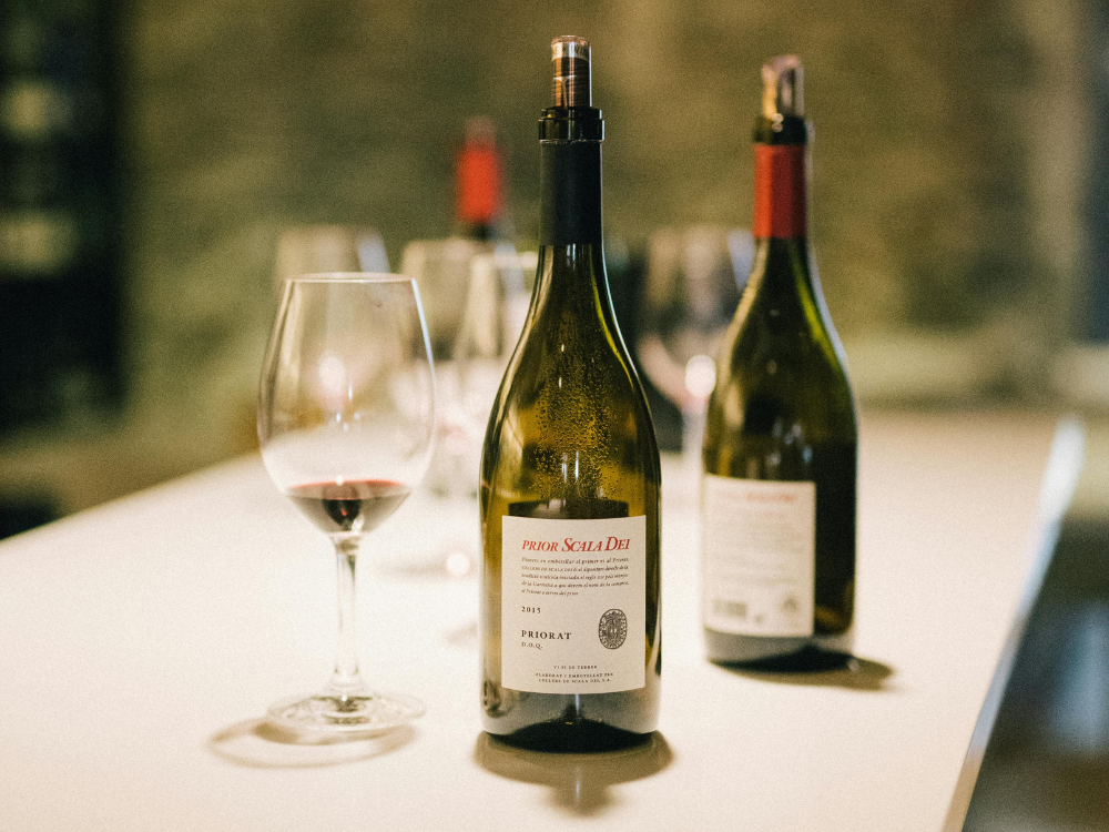Three red wines and empty glasses at a platinum fine wine experience london